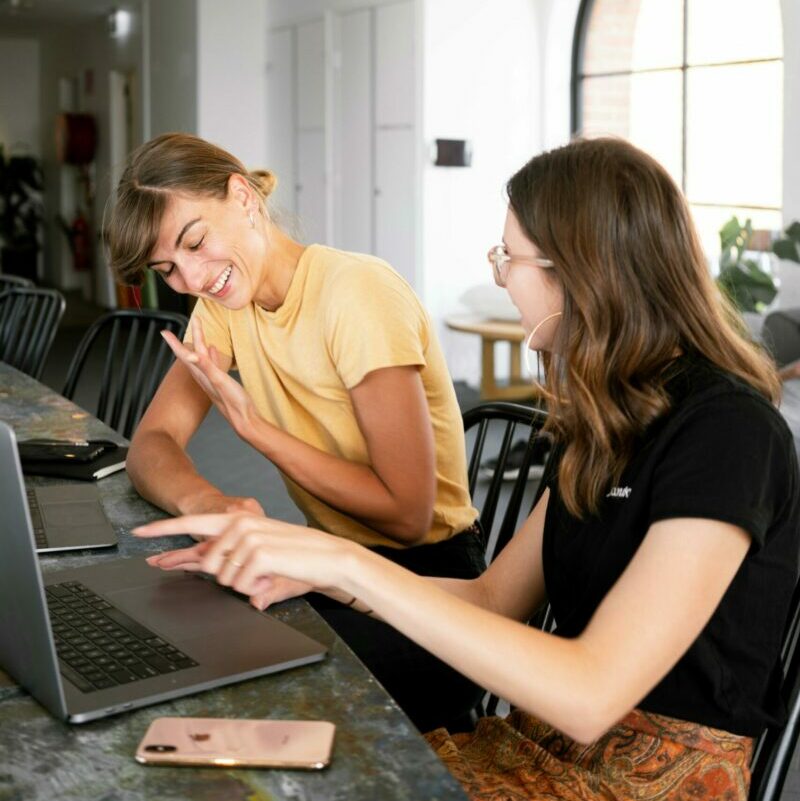 Group of architects discussing construction plans with hard hats in focus.